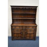 A GOOD QUALITY REPRODUCTION CARVED OAK DRESSER, double plate rack top, above a base with two drawers