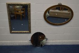 A GILT ON RESIN OVAL WALL MIRROR, along with a modern foliate bevelled edge wall mirror and a