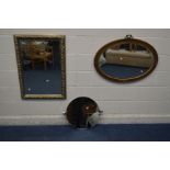 A GILT ON RESIN OVAL WALL MIRROR, along with a modern foliate bevelled edge wall mirror and a