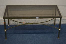 A RECTANGULAR BRASS AND SMOKED GLASS TOPPED COFFEE TABLE, on a cross stretchered base, length 91cm x