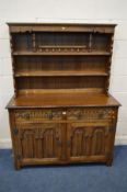 A CARVED OAK DRESSER, with two drawers, width 127cm x depth 48cm x height 168cm