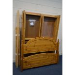 A MODERN PINE 4FT6 BEDSTEAD with four fitted drawers