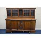 A LARGE HEAVY OAK DRESSER, with elaborately carved foliate and scrolled detail, the top section with
