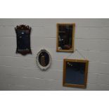 A REPRODUCTION WALNUT FRETWORK WALL MIRROR, 38cm x 64cm and an oak bevelled edge wall mirror and two