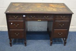 AN EDWARDIAN MAHOGANY DESK, with a distressed leather top, and seven drawers, width 123cm x depth