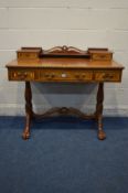 A REPRODUCTION MAHOGANY LADIES DESK, in the Victorian style, with five various drawers, twin