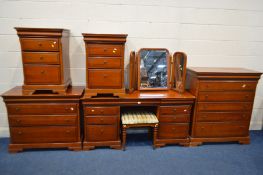 AN OLYMPUS CHERRYWOOD SEVEN PIECE BEDROOM SUITE, comprising a dressing table with an assortment of