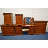 AN OLYMPUS CHERRYWOOD SEVEN PIECE BEDROOM SUITE, comprising a dressing table with an assortment of