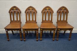 A SET OF FOUR REPRODUCTION OAK ECCLESIASTICAL CHAIRS, on octagonal front legs