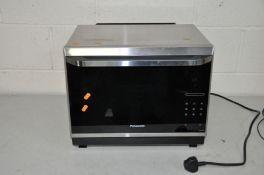 A PANASONIC NN-CF873S THREE IN ONE MICROWAVE, GRILL AND CONVECTION OVEN with manual 49cm wide 42cm