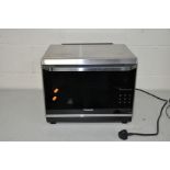 A PANASONIC NN-CF873S THREE IN ONE MICROWAVE, GRILL AND CONVECTION OVEN with manual 49cm wide 42cm