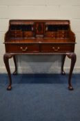 A REPRODUCTION MAHOGANY LADIES WRITING DESK, in the Victorian style, fitted with an assortment of