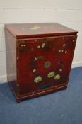A RED LAQUERED AND CHINOISERIE TWO DOOR TV CABINET, with hide away doors and internal compartment,
