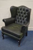 A GREEN LEATHER BUTTONED WING BACK ARMCHAIR (over sprayed)