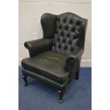 A GREEN LEATHER BUTTONED WING BACK ARMCHAIR (over sprayed)