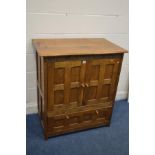 A REPRODUCTION PANELLED OAK TV CABINET with the year 1987 caved to the frieze, and two door that