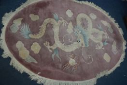 A CHINESE WOOLLEN PINK OVAL RUG, with dragon detail, 288cm x 194cm