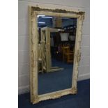 A CREAM FRENCH ORNATE RECTANGULAR BEVELLED EDGE WALL MIRROR, 150cm x 89cm and an oak oval wall
