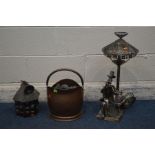 A FIGURAL METAL TABLE LAMP, of a seated man reading a book, along with a brass coal bucket