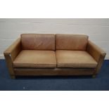 A BROWN LEATHER TWO SEATER SETTEE, on beech legs, width 194cm (sunlight faded leather)