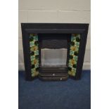 A CAST IRON FIRE PLACE INSERT with green tiles and fire grate, width 92cm x height 97cm