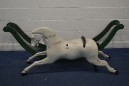 A EARLY VICTORIAN BOW ROCKING HORSE, later painted white and loose from a green painted base,