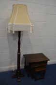 AN OLD CHARM OAK STANDARD LAMP, with a gold fabric shade, height including shade 183cm and an oak