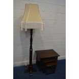 AN OLD CHARM OAK STANDARD LAMP, with a gold fabric shade, height including shade 183cm and an oak