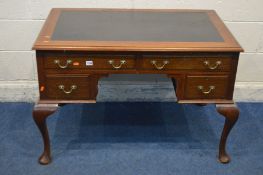 AN EDWARDIAN MAHOGANY WRITING DESK with black leatherette top, and four drawers, on cabriole legs,
