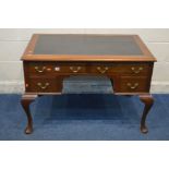 AN EDWARDIAN MAHOGANY WRITING DESK with black leatherette top, and four drawers, on cabriole legs,