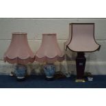 A BURGUNDY CERAMIC TABLE LAMP and a pair of floral ceramic table lamps, all with pink fabric