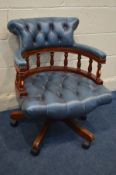 A MAHOGANHY FRAMED AND BUTTONED BLUE LEATHER SWIVEL OFFICE CHAIR