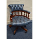 A MAHOGANHY FRAMED AND BUTTONED BLUE LEATHER SWIVEL OFFICE CHAIR