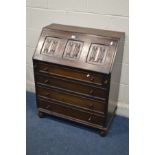 A REPRODUCTION OAK LINENFOLD BUREAU with four drawers, width 76cm x depth 41cm x height 94cm