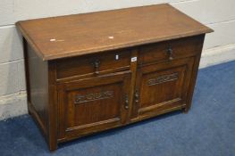 A LOW OAK TWO DOOR CABINET with two drawers, width 108cm x depth 48cm x height 63cm (missing back)