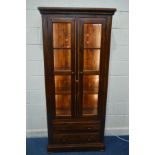 A DARK HARDWOOD GLAZED TWO DOOR BOOKCASE with led lighting strips and three shelves, above two