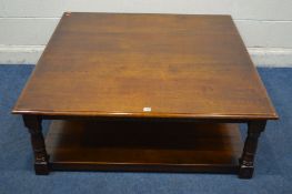 A REPRODUCTION SQUARE OAK COFFEE TABLE, on block and turned legs united by an undershelf, 122cm