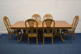 A HARDWOOD FINISH EXTENDINING DINING TABLE, with two additional leaves, length 245cm x closed length