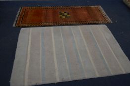 A RED WOOLLEN CARPET RUNNER, 214cm x 81cm and a stripped rug, 185cm x 121cm (stripped carpet