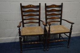 A PAIR OF 20TH CENTURY GEORGIAN STYLE ELM AND OAK LADDERBACK ELBOW CHAIRS with rush seats