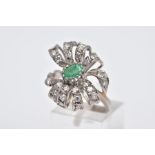 A WHITE METAL EMERALD AND DIAMOND RING, set with a central oval cut emerald (internal fracture