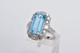 A MODERN AQUAMARINE AND DIAMOND RECTANGULAR CLUSTER RING, centering on a step cut aquamarine