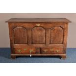 A GEORGE III OAK MULE CHEST, two plank hinged top above three fielded panels, two short drawers