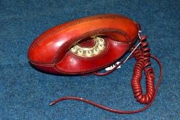 A LEATHER COVERED GENIE PUSH BUTTON TELEPHONE, appears complete, used condition, marking and wear to