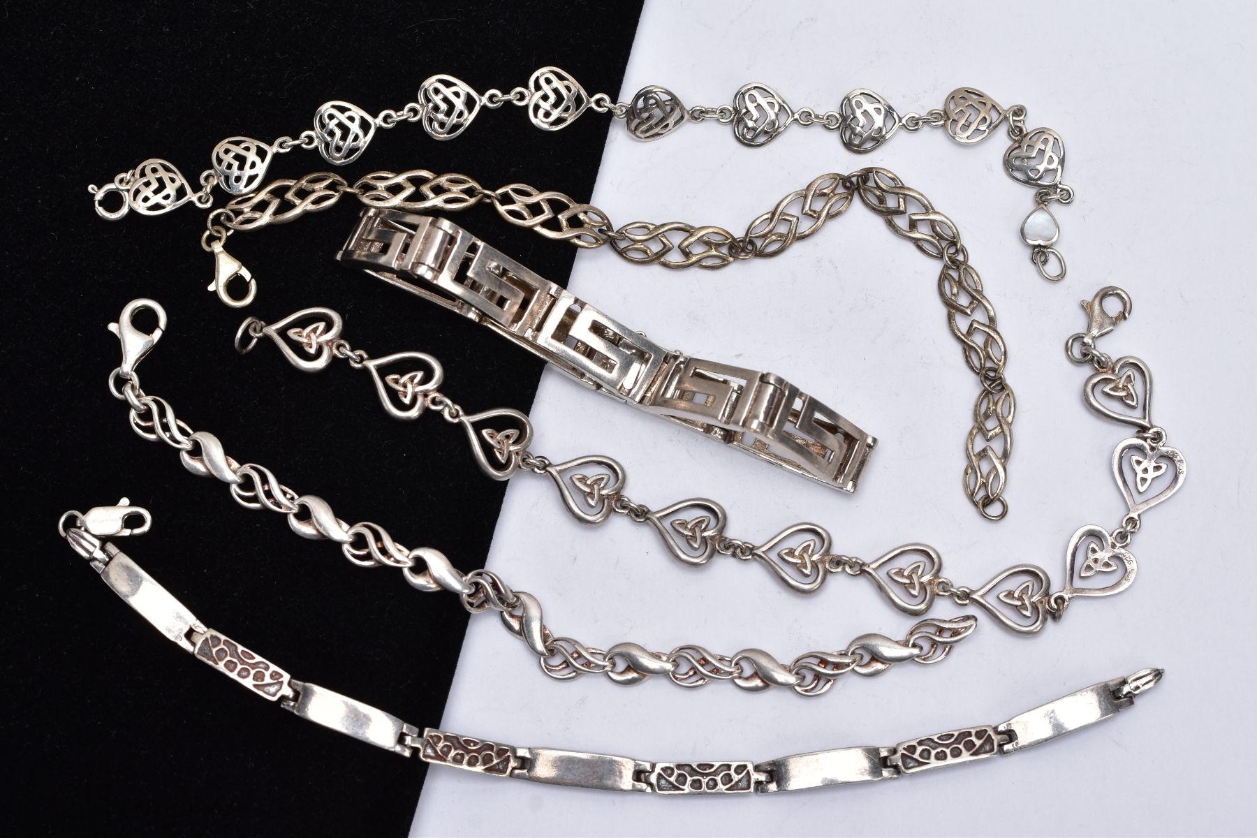 A BAG OF ASSORTED SILVER AND WHITE METAL BRACELETS, to include a silver Greek key style bracelet,