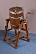 A LATE 19TH/EARLY 20TH CENTURY COOPERED BARREL BUTTER CHURN ON STAND, the churn with plaque and cast