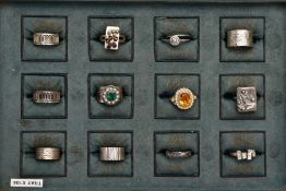 A TRAY OF ASSORTED WHITE METAL RINGS, twelve rings in total, such as three textured wide bands,