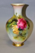 A ROYAL WORCESTER BALUSTER VASE PAINTED WITH PINK AND YELLOW ROSES, on a blush ivory ground,