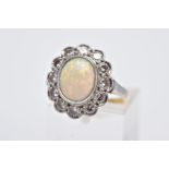 A WHITE METAL OPAL AND DIAMOND CLUSTER RING, designed with an oval opal cabochon, within a