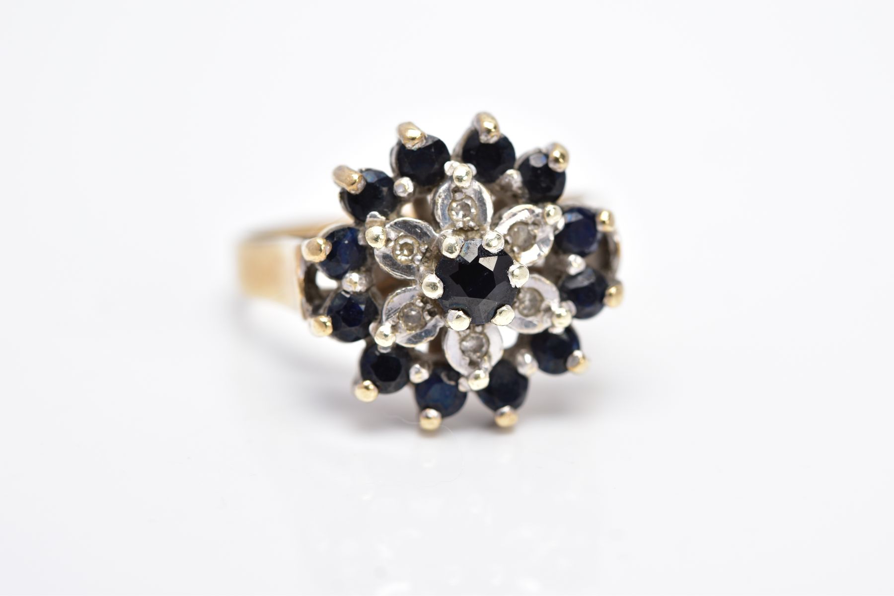 A 9CT GOLD SAPPHIRE AND DIAMOND CLUSTER RING, the raised cluster set with a claw set, circular cut - Image 4 of 4